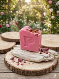 Prudent Preservations artisan bar soap with soft pink hues and dried rose petal botanicals.