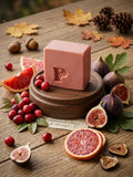 Prudent Preservations artisan bar soap with warm cranberry red and golden amber swirls, handcrafted cold-process.