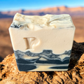 Prudent Preservations Artisan Swirl Bar Soap with embossed P logo, white and charcoal grey marbled design, handcrafted for cleansing and nourishing.