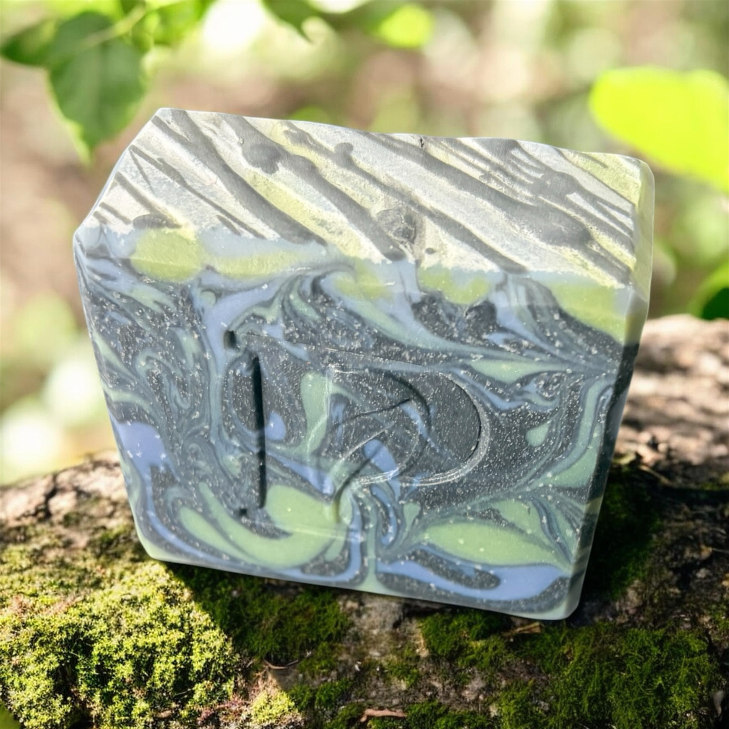 Prudent Preservations artisan bar soap with swirled charcoal gray, moss green, and sky blue natural ingredients.