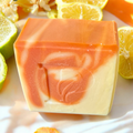 Prudent Preservations marbled artisanal soap with orange and cream swirls, infused with natural ingredients.